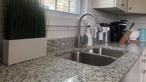 A kitchen with granite countertops, stainless steel sinks, and white cabinets. - *20% OFF Newly Remodeled #3* 5min walk to the Beach, Amazing Virginia Pro Host.  (Norfolk)
