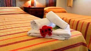 A hotel room with a bed, a nightstand, a lamp, and a mirror. - d Pietraia 13B Trilo (Badesi)