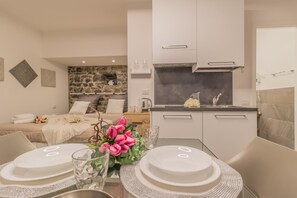 Cozy living area with a sofa set and kitchenette, perfect for a compact retreat.