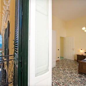 Classic hotel corridor with a patterned floor and a traditional door leading to another room.