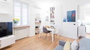 A modern, well-lit apartment with a dining area, kitchen, and living room. - Co-c933-dott13a2 - Rosart House (Como)