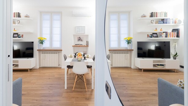 A modern, well-lit kitchen with white cabinetry, a dining table, and a TV. - Co-c933-dott13a2 - Rosart House (Como)