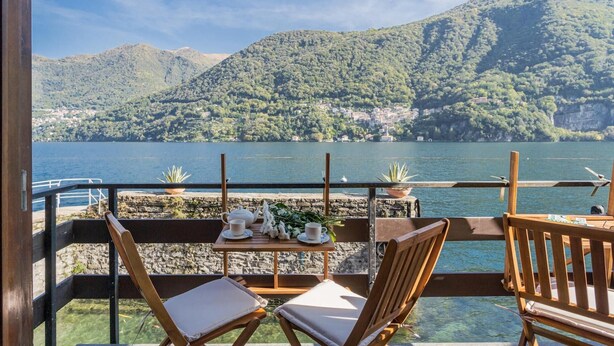 A terrace with a table set for two, overlooking a lake and mountains. - Co-e405-regi74a1 - Your Private Harbour Nearby George Clooney (Carate Urio)