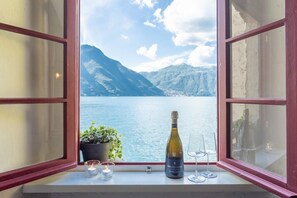 Enjoy a romantic view of the water and mountains from this room, complete with a champagne and glasses on the windowsill.