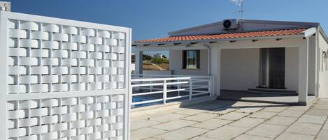 A modern building with a tiled roof and a white exterior.