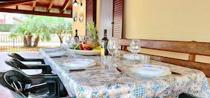 Guests can dine in style with a beautifully set table, complete with fine china and a fruit bowl.