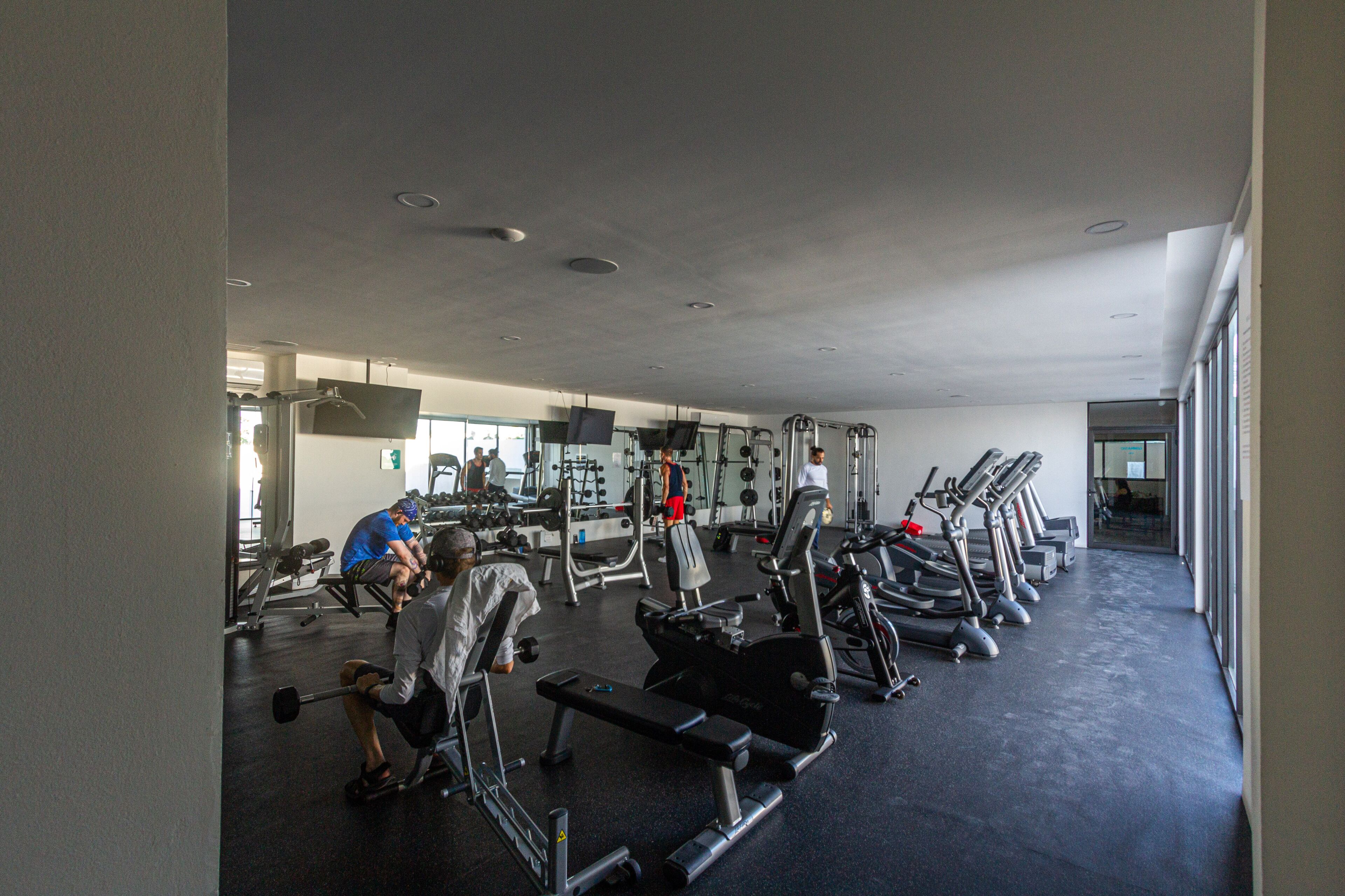 A gym with various exercise equipment, including treadmills and weight machines.