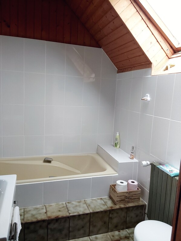 Bathtub, hair dryer, towels, soap