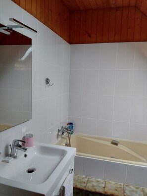 Bathtub, hair dryer, towels, soap