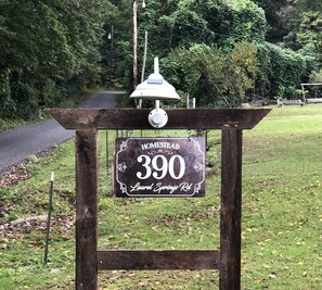 Welcome to Laurel Springs Rd, where a rustic sign marks the entrance to a serene and peaceful setting.