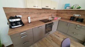Fridge, stovetop, dishwasher, coffee/tea maker