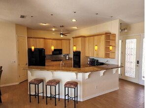 Enjoy cooking in this well-equipped kitchen with a central island and stainless steel appliances.