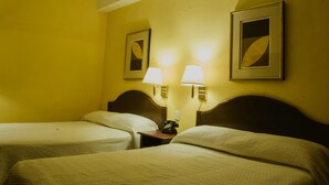 A hotel room with two beds, a nightstand with a telephone, and two wall-mounted lamps. - Hotel Posada San Agustin (Durango)