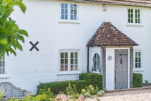 A white building with a small porch and a door. - Charming countryside cottage with large garden (Hammill)