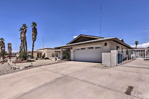 A residential house with a garage, a driveway, and palm trees. - 4 Mi to Lake Havasu: Luxe Home w/ Outdoor Oasis (Lake Havasu City)