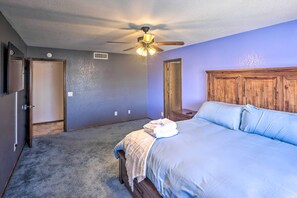 A bedroom with a bed, a ceiling fan, and a wooden headboard. - 4 Mi to Lake Havasu: Luxe Home w/ Outdoor Oasis (Lake Havasu City)