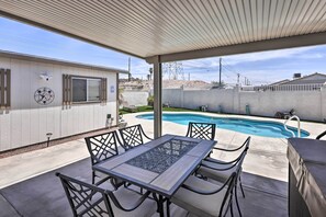 A covered patio area with a pool, outdoor furniture, and a view of a residential building. - 4 Mi to Lake Havasu: Luxe Home w/ Outdoor Oasis (Lake Havasu City)