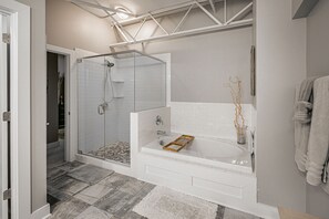 Enjoy a refreshing shower or soak in the bathtub in this bathroom with a walk-in shower and tub.