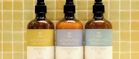 Three bottles of Authentic Organics products: Shampoo, Conditioner, and Body Wash.