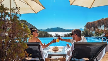 Outdoor pool, open 10:00 AM to 8:00 PM, pool umbrellas, pool loungers