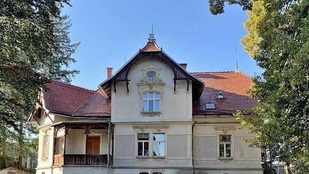 A large, historic building with a symmetrical facade, a central entrance, and a red-tiled roof. - Spacious holiday home in Šluknov with private garden (Šluknov)