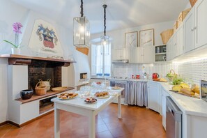 Enjoy cooking in this well-appointed kitchen with a central island, fireplace, and ample counter space.