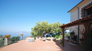 A patio with outdoor furniture, a pergola, and potted plants. - Villa Posidonia in Massa Lubrense (Massa Lubrense)