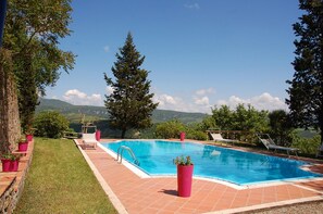 A swimming pool with a clear view of the mountains in the background.
