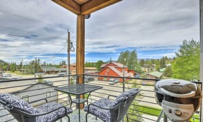 A balcony with a grill and outdoor seating. - Grand Lake Condo w/ Balcony & Mountain Views (Grand Lake)