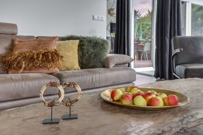 Relax in this inviting living room with a comfortable sofa, coffee table, and beautiful view.