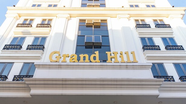 A grand, white building with the name "Grand Hill" prominently displayed above the entrance. - Grand Hill Apartment & Hotel (Hai Phong)