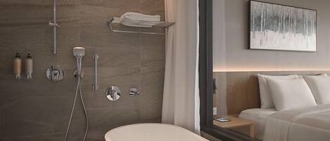 A modern bathroom with a freestanding bathtub, a shower with a handheld showerhead, and a towel rack.