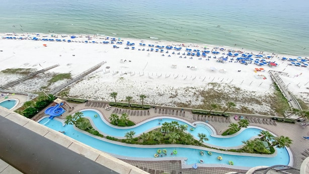 A resort with a beach, a pool area with slides, and a boardwalk. - New Owner, New to the Rental Market, Lazy River/Slide!! (Orange Beach)