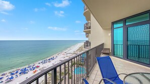 A balcony with a view of a beach and a pool. - New Owner, New to the Rental Market, Lazy River/Slide!! (Orange Beach)