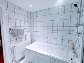 Combined shower/bathtub, towels, soap, toilet paper