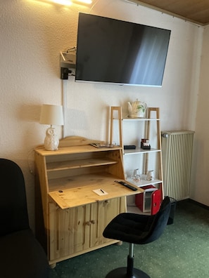 Enjoy a well-organized space with a desk, flat-screen TV, and cozy seating area.