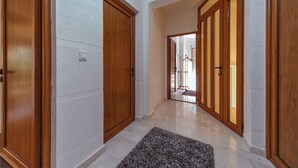 A hallway with wooden doors and a carpet. - Second Floor (Бјелиши)