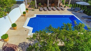 A swimming pool with lounge chairs, a covered patio, and potted plants. - Second Floor (Бјелиши)