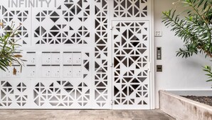 A modern building facade with geometric patterns and a sign reading "INFINITY I". - Infinity 1.2 LUXE PARTIAL SEA VIEW 2B (Arona)