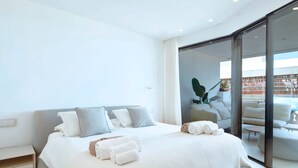 A modern hotel room with a large bed, a glass door leading to a balcony, and a minimalist design. - Infinity 0.3 LUXE PARTIAL SEA VIEW 2B (Arona)