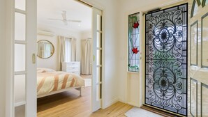 A bedroom with a bed, a dresser, and a mirror. - The Parkers - in the Heart of Bright (Bright)