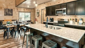 A kitchen with granite countertops, stainless steel appliances, and wooden cabinetry.