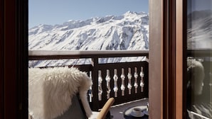 A balcony with a view of snow-covered mountains.