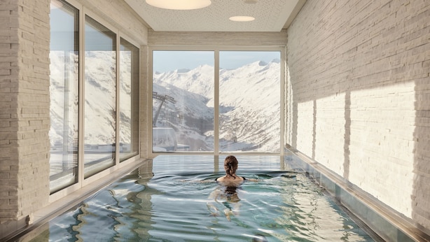 A spa room with a large window offering a mountain view.