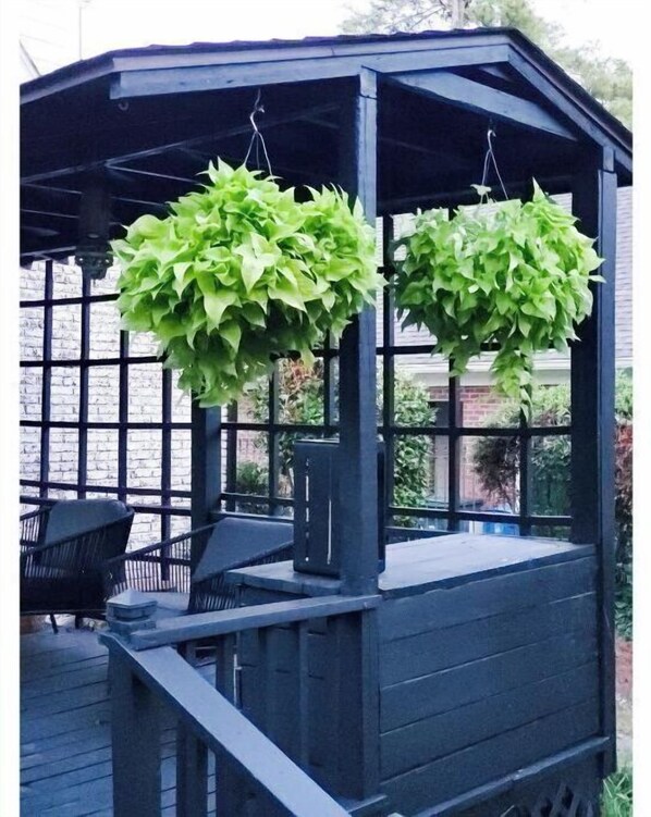 Situated on a wooden deck, this gazebo offers a serene space for relaxation or dining.