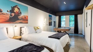 A modern hotel room with two beds, a pool table, and a large painting of a person playing basketball on a planet. - Massive Compound Near Rainey St - Hot Tub, Pool (Austin)