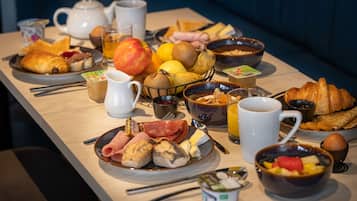 A breakfast buffet with various foods and beverages.