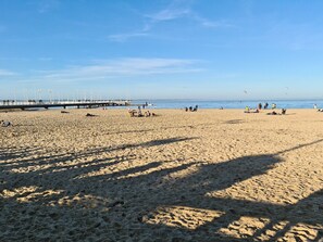 A wide sandy beach with a pier in the background and people scattered across the sand. - Nice 86m² With Terrace Near The Beach! (Arcachon)