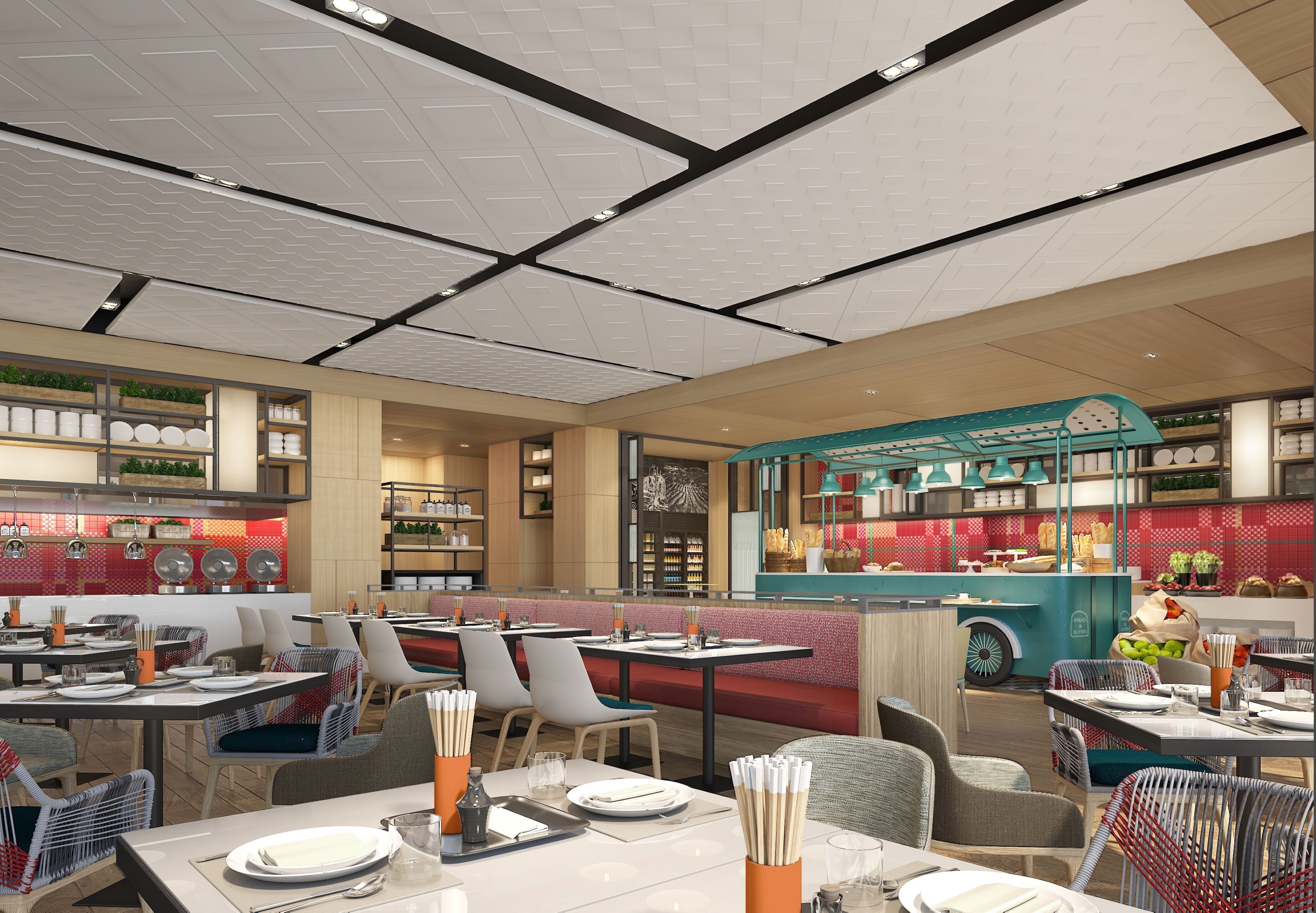 A modern restaurant interior with tables, chairs, and a food truck.