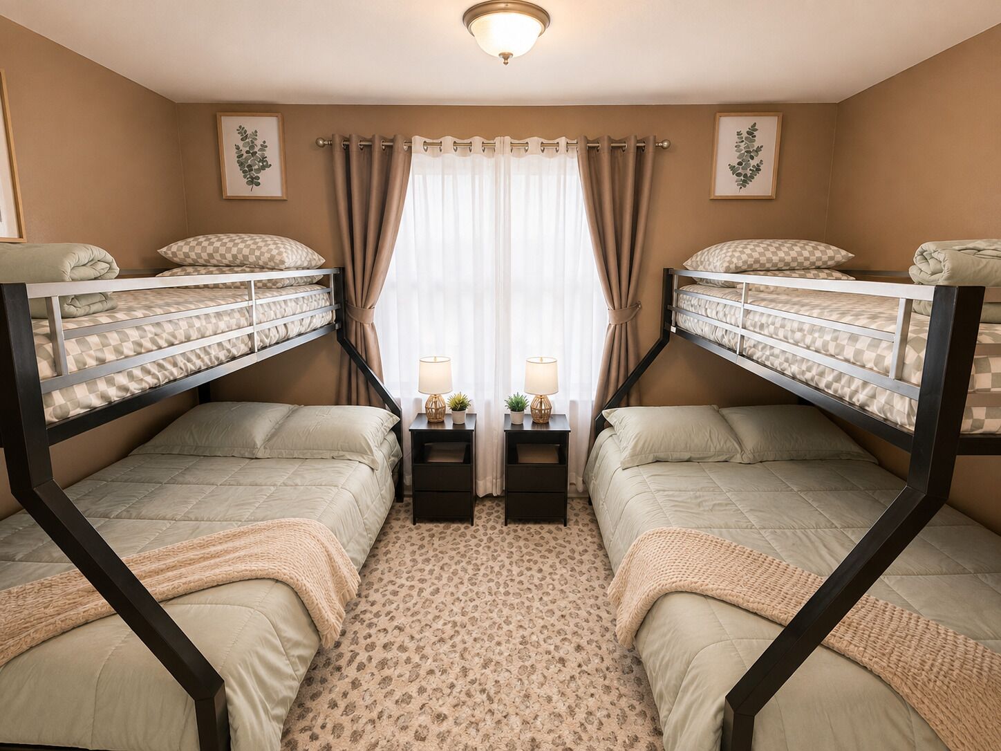 A room with two bunk beds, a small bedside table with a lamp, and a window with curtains.